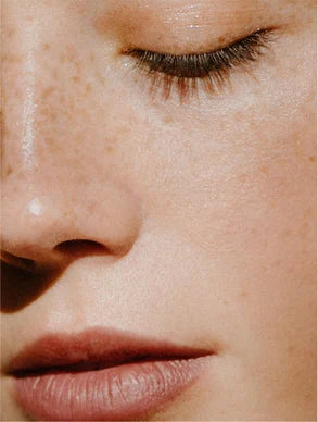 detailed skin texture with natural glow and freckles, even complexion and healthy hydrated facial skin