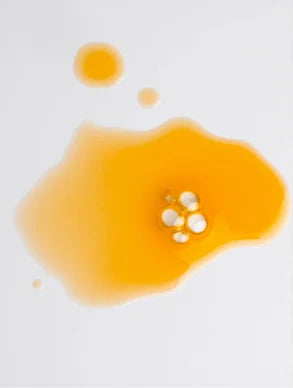 golden facial oil texture with bubbles, hydrating nourishing glow oil for radiant smooth healthy skin
