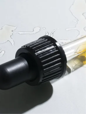 facial oil dropper with golden oil texture, hydrating botanical face oil for smooth radiant and nourished skin
