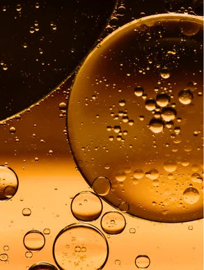 Golden omega-rich body oil texture with bubbles, lightweight nourishing oil with sunflower, almond, jojoba, argan and rosehip oils for deep hydration, smooth skin and radiant glow skincare product