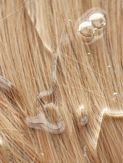 hydrating shampoo texture on blonde hair strands, moisturising and strengthening formula for soft shiny healthy hair