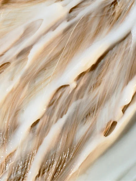 rich creamy hair mask texture on hair strands, deep nourishing treatment for dry damaged hair, repair strengthening and shine boosting effect